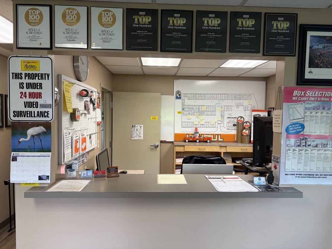 ABC Storage office counter with Top 100 U-Haul dealer awards and box selection guide