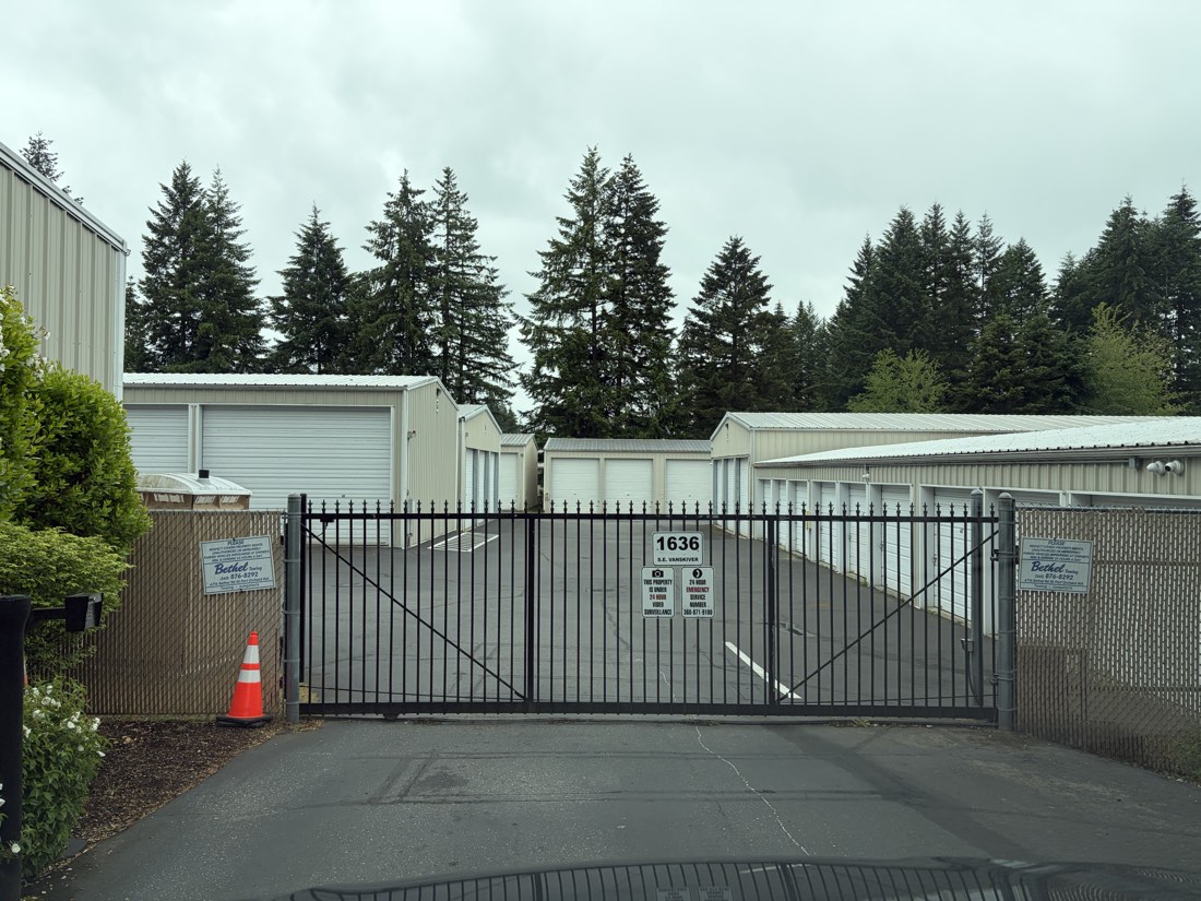 Secured front gate at ABC Storage with storage units behind